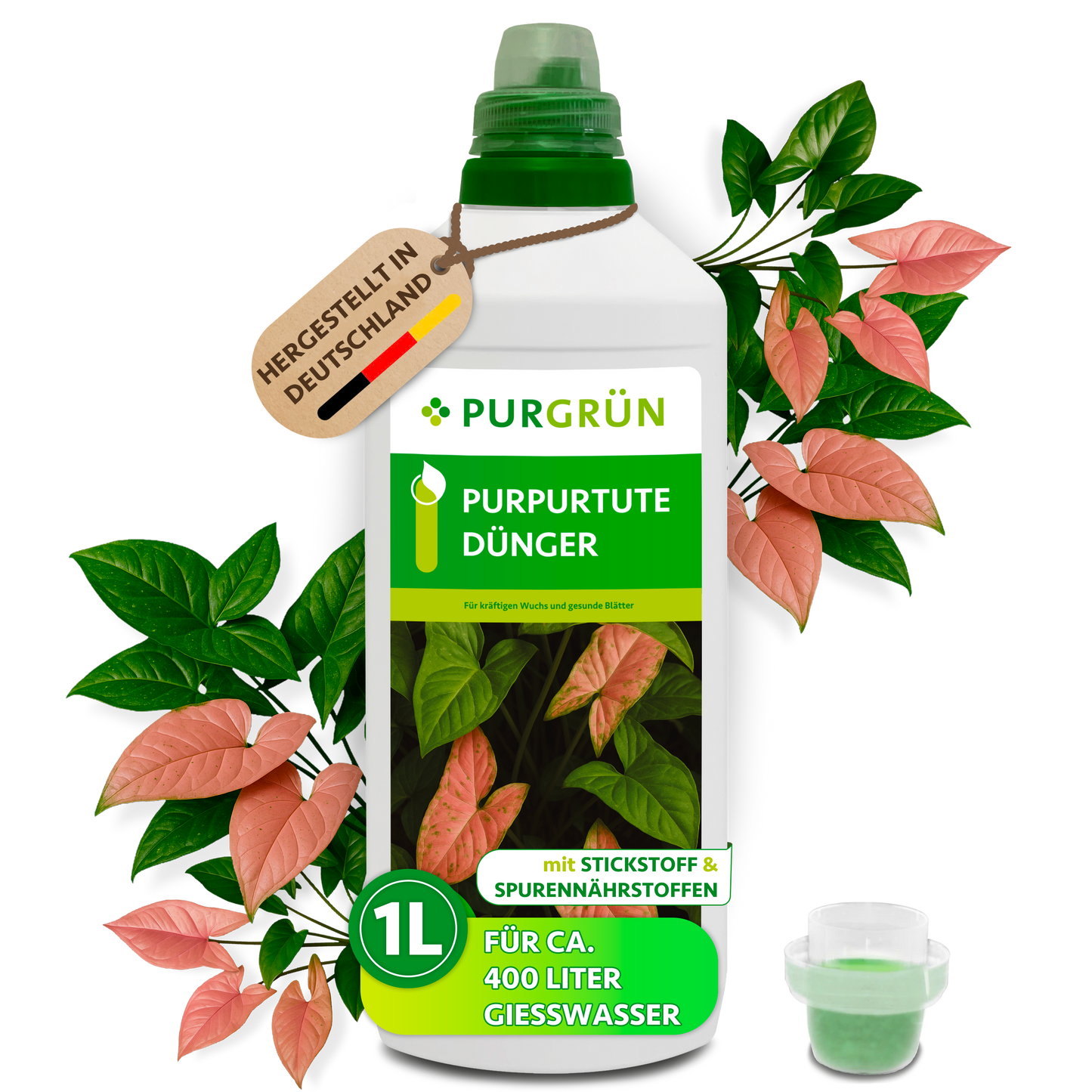 Purgrün Purpurtute-Dünger in der 1-Liter-Flasche mit Dosierkappe, umgeben von Purpurtute-Blättern und mit Anhänger „Hergestellt in Deutschland“.